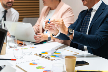 Business people working together at conference table analyzing financial charts