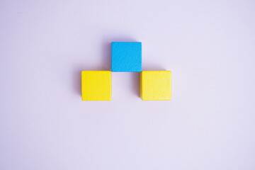 Symmetrical yellow and blue blocks on light background with copy space symbolizing balance, minimalism, and creative business concepts