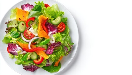 Colorful salad on white plate.  Fresh mix of greens, vegetables.  Overhead view