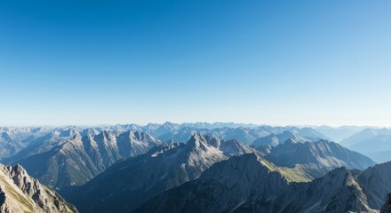 Naklejka premium Panoramic View of Majestic Mountain Range under a Clear Blue Sky