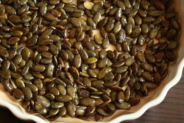 freshly baked pumpkin seeds lightly salted and arranged on a baking tray