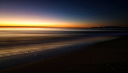 Sunset Seascape with Golden Horizon over Dark Beach and Water Reflections with Ripples Under Dramatic Sky