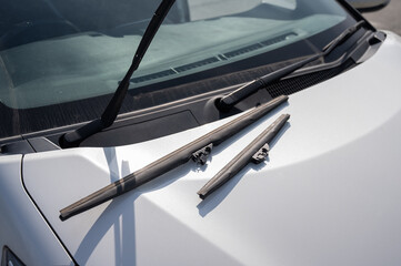 Windscreen wipers lying on the hood. Seasonal replacement. 