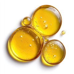 Golden liquid droplets, various sizes, clustered on a white background.  A top-down, close-up view showcasing the translucent, amber-hued liquid.  