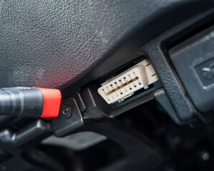 Woman using OBD2 diagnostic scanner. 