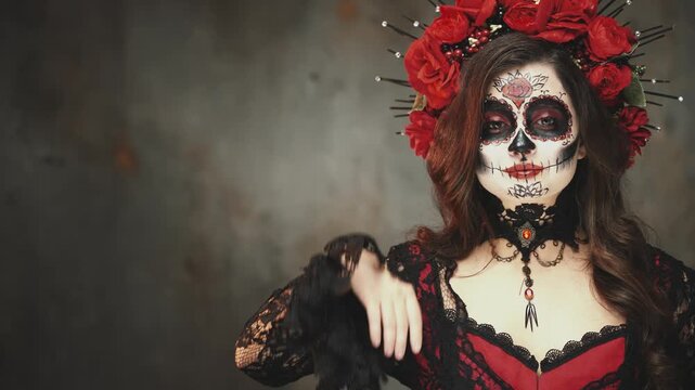 happy woman smiling face close up hands showing pointing copy space for advertising gray background. Holiday Lifestyle sceleton sugar skull halloween makeup Girl Calavera black dress. day of the dead