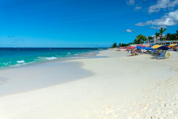 People and parasols in Shoal Bay beach, Caribbean dream landscape in Anguilla island, British West Indies