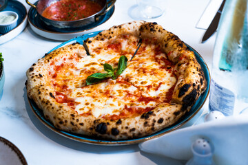 Pizza with salad and  juice on marble table Morocco September 3, 2025