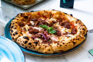 Pizza with salad and  juice on marble table Morocco September 3, 2025