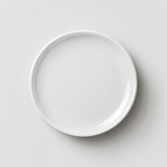 High-angle, top-down view of a round, white plate, set against a plain white background.  The plate is smooth and has a subtle curve to its rim.  A soft shadow is cast underneath