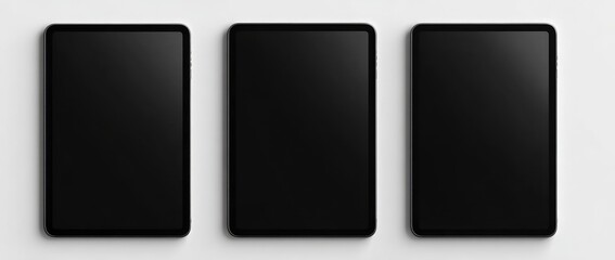 Three black tablets on a white surface (1)