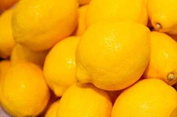 Close up Pile of lemons displayed for sale at market. Lemon background