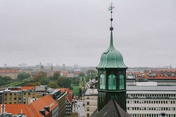 View of Trinitatis Kirke from the Round Tower in Copenhagen city, Denmark on rainy day.