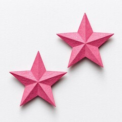 Obraz premium Two pink paper stars on a white background