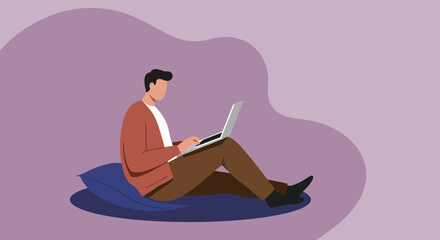 Relaxed senior man with a beard and glasses sits comfortably on a beanbag, focused on his laptop. Illustrates modern digital lifestyle and remote work for older adults.