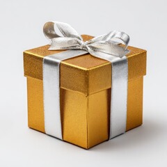 Gold gift box with silver ribbon.  A small, square gift box, gold in color with a metallic shimmer, is presented on a plain white background. 