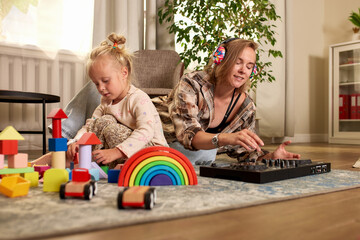 Obraz premium Mother and daughter sharing creative time in a cozy playroom
