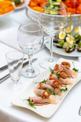 A plate of ham rolls with cheese filling and pea shoots garnish