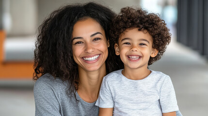 Happy mother and child smiling together in modern indoor setting, showcasing joy and connection