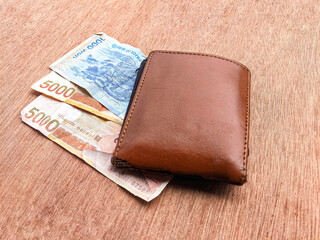 Wallet and banknotes in one thousand and five thousand yen denominations