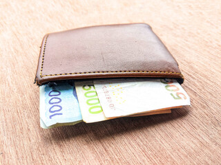 Wallet and banknotes in one thousand and five thousand yen denominations