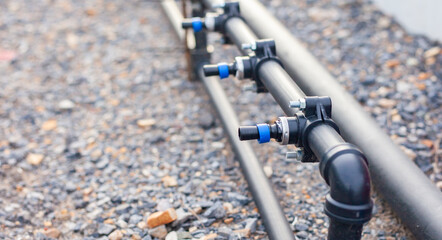 Close-up of an agricultural water management infrastructure system with pipes and valves. Modern agriculture. Maintenance of agricultural irrigation systems.