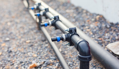 Close-up of a water pump. Agricultural water piping system. PVC pipe connectors.