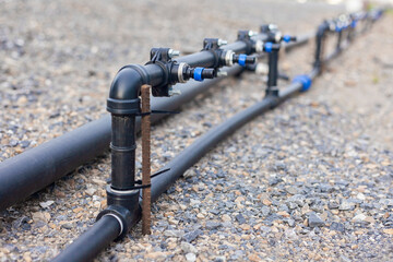 Close-up of a water pump. Agricultural water piping system. PVC pipe connectors.