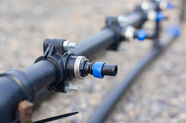 Close-up of a water pump. Agricultural water piping system. PVC pipe connectors.
