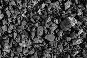 Photo of Big pile of natural black coals. Background texture for backdrops or mapping.Preparation and Laying of asphalt. Textured background. Construction industry.