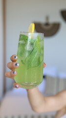 woman pouring cocktail into glass