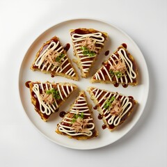 Okonomiyaki Slices with Mayonnaise Sauce Bonito Flakes on white plate on white background 