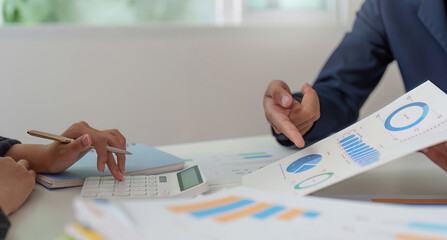 Financial Consultation. Professionals discussing budget charts and graphs in a collaborative setting.