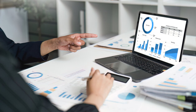 Data Analysis and Reporting. Business professional analyzing financial charts on laptop.