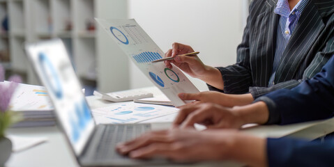 Data Visualization. Business team analyzing financial reports with charts and graphs.