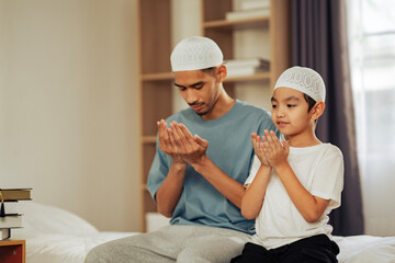 Father and child wearing white kufi caps engaged in Islamic prayer, reflecting cultural traditions, spirituality, and intergenerational learning for education and religious projects.