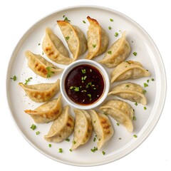 top view of gyoza dumplings with sauce on white plate 