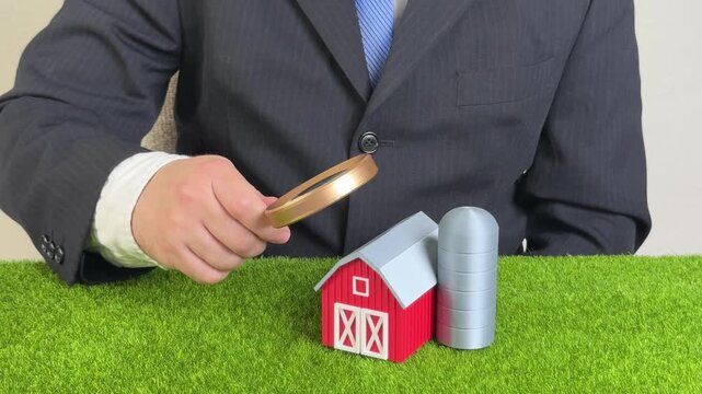 Man studying a farm on a plot of land. Construction and building. Development of farms. Land ownership, countryside migration. Rural revitalization, sustainable development, and self-sufficiency.