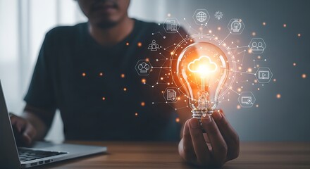 Man holding light bulb with cloud computing and technology icons for business solutions