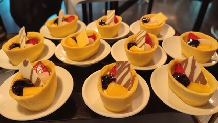Assorted sweet dessert cups with fresh fruits