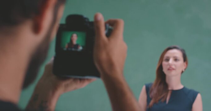 Model posing during studio photoshoot, focus shift from camera screen