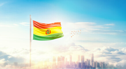 Bolivia flag wavering in beautiful clouds with building skyline. The flag with drone shot in beautiful sky. Bolivia national flag for independence day.