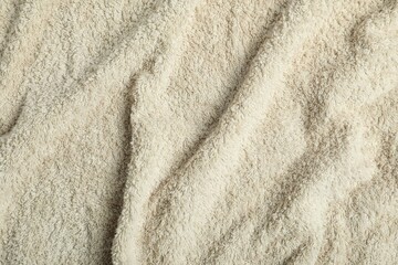 Light green terry towel as background, top view