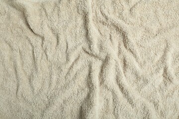 Light green terry towel as background, top view