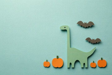 Green dinosaur orange pumpkin black bat paper cut minimal style Halloween cute flat design blue background autumn
