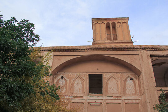 Historic windcatcher and adobe house in Yazd, Iran, showcasing traditional Persian desert architecture and cultural heritage.
