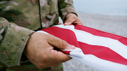 American Soldier Folding The USA Flag