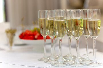 Festive table with sweet snacks, fruits, and champagne flutes