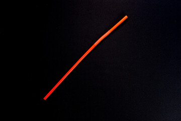 Orange Plastic Drinking Straw on Dark Background