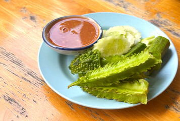 Traditional Thai food side dish, fresh and steamed vegetables and spicy salty sauce from shrimp paste and herbs - called Nam Prick in Thai language.